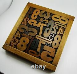 29 pieces vintage/antique letterpress wood type numbers in a frame withstand