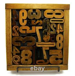 29 pieces vintage/antique letterpress wood type numbers in a frame withstand
