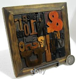 33 pcs. Vintage/antique letterpress in a stained wood frame with black stand