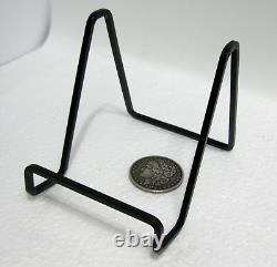 33 pcs. Vintage/antique letterpress in a stained wood frame with black stand