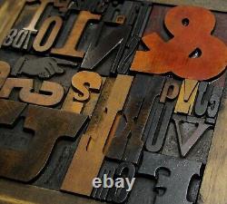 33 pcs. Vintage/antique letterpress in a stained wood frame with black stand