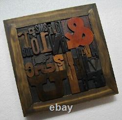33 pcs. Vintage/antique letterpress in a stained wood frame with black stand