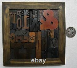 33 pcs. Vintage/antique letterpress in a stained wood frame with black stand