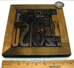 35 pcs. Vintage/antique letterpress in a stained wood frame with brown stand