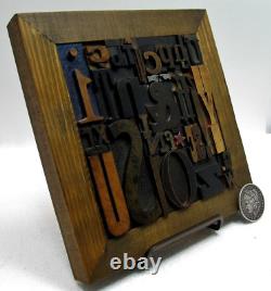 35 pcs. Vintage/antique letterpress in a stained wood frame with brown stand