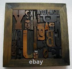 36 pcs. Vintage/antique letterpress in stained wood frame with square iron stand