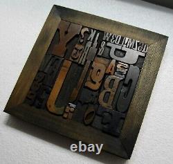 36 pcs. Vintage/antique letterpress in stained wood frame with square iron stand