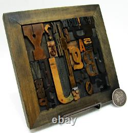 36 pcs. Vintage/antique letterpress in stained wood frame with square iron stand