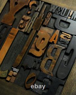 36 pcs. Vintage/antique letterpress in stained wood frame with square iron stand