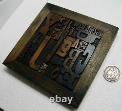 36 pcs. Vintage/antique letterpress in stained wood frame with square iron stand