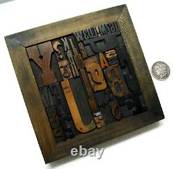 36 pcs. Vintage/antique letterpress in stained wood frame with square iron stand