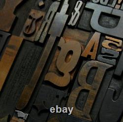 36 pcs. Vintage/antique letterpress in stained wood frame with square iron stand