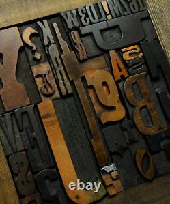 36 pcs. Vintage/antique letterpress in stained wood frame with square iron stand