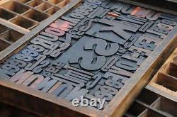 Collage KISS made of letterpress wood type characters in antique drawer old