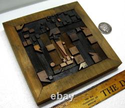 Vintage/antique letterpress punctuation marks in stained wood frame with stand