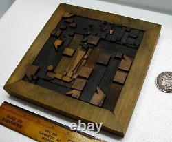 Vintage/antique letterpress punctuation marks in stained wood frame with stand
